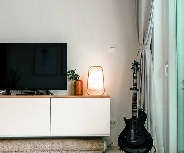 bild-text-quartierstrom-tv-fernseher-elektrische-gitarre-wohnzimmer-lampe-licht